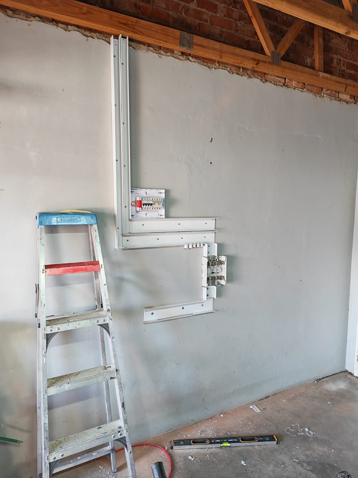 Electrical installation conduit mounted on wall before final fit-off